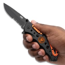 Hand holding black and orange folding knife