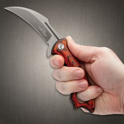 Hibben Firebird wood Folding Karambit in hand