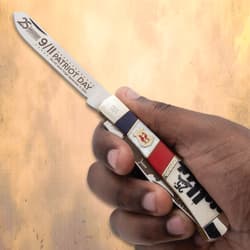 Hand holding a 9/11 commemorative knife with patriotic design
