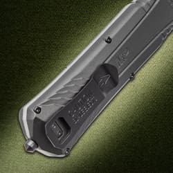 Close-up of knife handle with caution text on textured background
