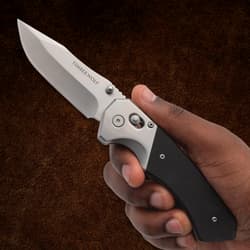 Hand holding a silver folding knife with black handle