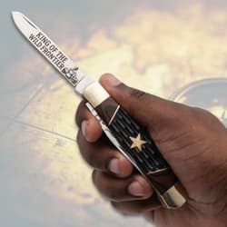 Hand holding a knife with engraved blade