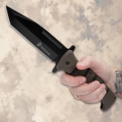 Hand holding USMC tactical knife