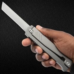 Hand holding a stainless steel folding knife