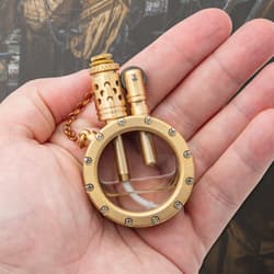 Hand holding a vintage brass kerosene lighter.