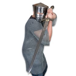 Person in armor holding a sword ready to strike