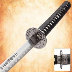 Close-up of katana handle and engraved guard with dragon design