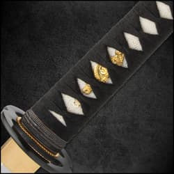 The 28 3/4”, hand-forged 1045 carbon steel blade is razor-sharp, and it extends from a brass habaki