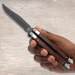 Hand holding a butterfly knife with wooden handles