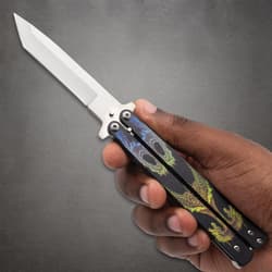 Hand holding butterfly knife with dragon design on handle