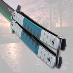 Close-up of butterfly knife handle with blue and green design