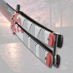 Close-up of butterfly knife handle with flame design