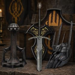 Medieval sword, shield, and helmet with intricate designs on a wooden chest