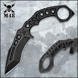 Black karambit with open-ring handle on surface