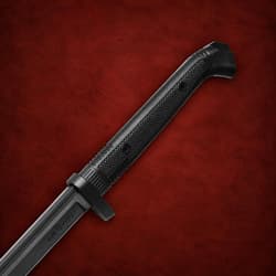Black knife handle on a red textured background