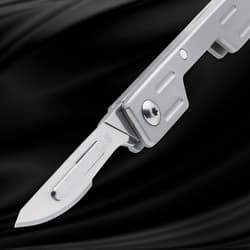 Silver folding knife with partially open blade