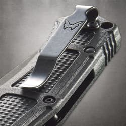 Close-up of knife handle with metal clip and logo