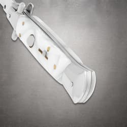 Close-up of white pearl stiletto knife handle