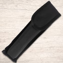 Black knife sheath on wooden background