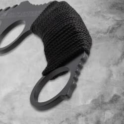 Close-up of the cord-wrapped handle of a karambit knife