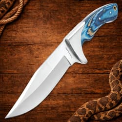 Knife with blue handle on wooden surface with rope