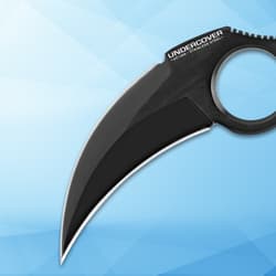 Close-up of black karambit blade on blue background
