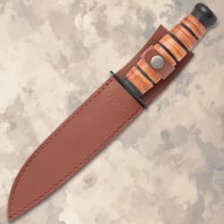 Knife in a brown leather sheath with USMC embossing