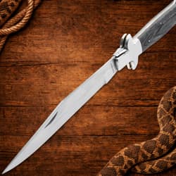 Open Timber Rattler knife with wooden handle on wood background