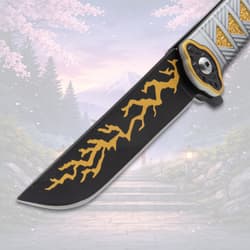 Close-up of knife blade with yellow lightning pattern