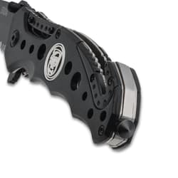 Close-up of knife handle with skull logo and clip