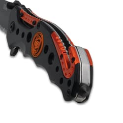 Close-up of knife handle with orange accents