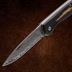 Open folding knife showing detailed Damascus blade pattern
