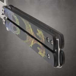 Close-up of butterfly knife handle with dragon artwork