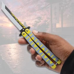 Hand holding a butterfly knife with yellow and gray handle