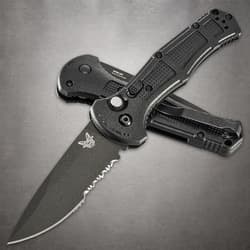 Two black folding knives, one open, one closed