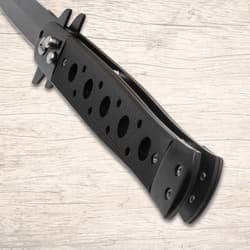 Close-up of black knife handle with holes