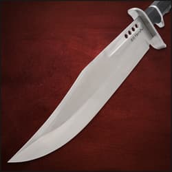 Large knife blade on red background