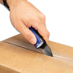 Left hand with watch on wrist uses black pocket knife lighter caddy with blue "BIC" lighter to open brown cardboard box.