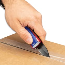 Left hand with watch on wrist uses black pocket knife lighter caddy with blue "BIC" lighter to open brown cardboard box.