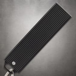 Black closed knife handle with a keyring on a gray background