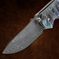 Detailed view of etched blade on a pocket knife