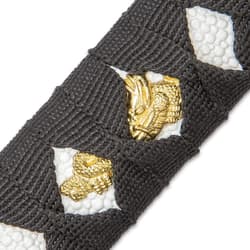 An ornate gold color design can be seen peeking out from the black cord wrapping the handle of the Samurai sword.