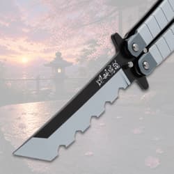 Close-up of butterfly knife blade with scenic background