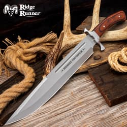 Large knife with wooden handle on rustic background