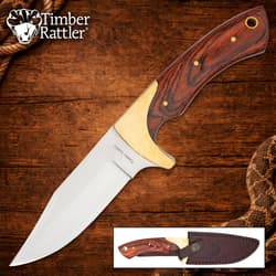 Knife with wooden handle and leather sheath on wooden background