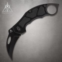 Black folding knife with textured grip and ring handle