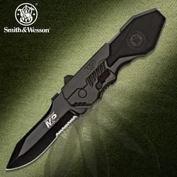 Black tactical knife with Smith & Wesson logo on green background