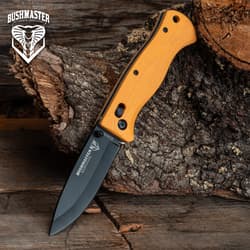 Orange-handled knife on wood and bark background