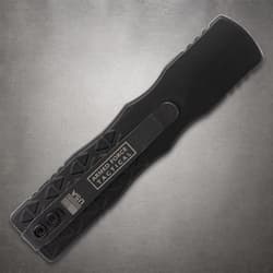 Back view of black tactical knife with pocket clip