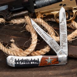 Knife with Wild West engravings, rope, and gun